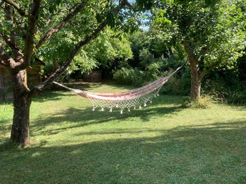Garten genießen in Hängematte in natürlichem Garten mit viel Grün